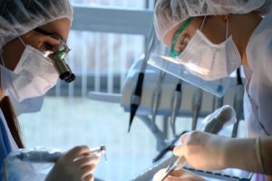 dental personnel sterilizes surgical instruments